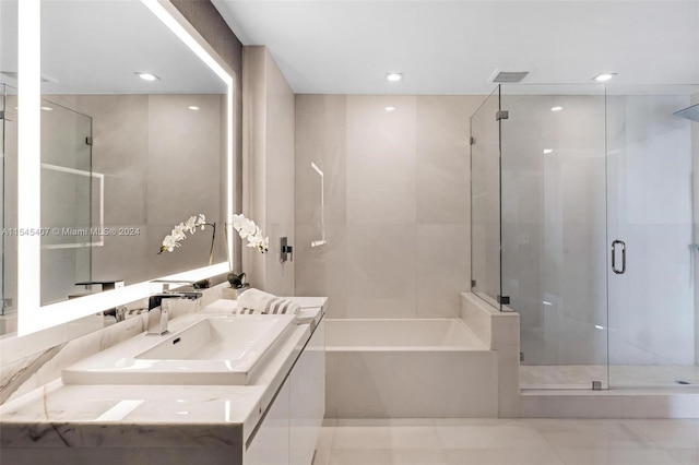 bathroom featuring vanity, tile flooring, and independent shower and bath