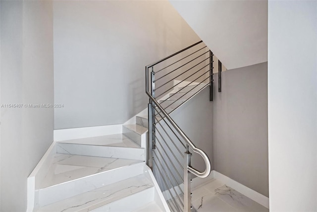 staircase featuring light tile floors