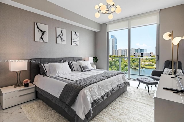 bedroom with a notable chandelier, a wall of windows, access to outside, and a water view