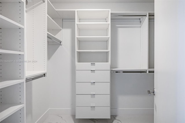 spacious closet with light tile floors