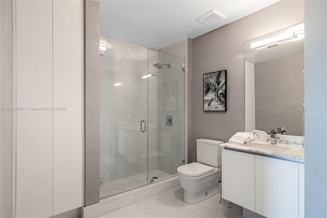 bathroom with toilet, vanity, a shower with shower door, and tile flooring