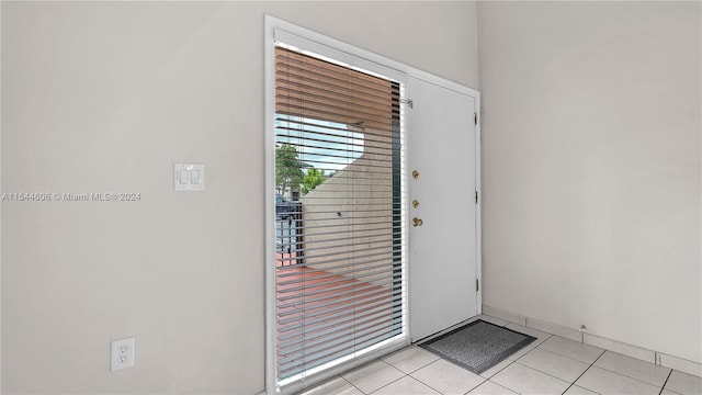 entryway with light tile patterned flooring