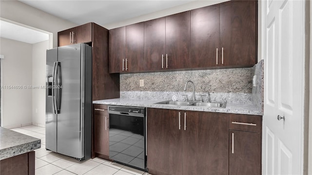 kitchen featuring stainless steel fridge, black dishwasher, light tile patterned floors, sink, and decorative backsplash