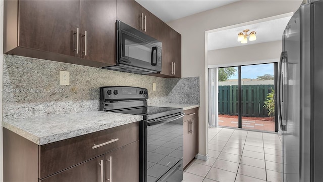 kitchen featuring a chandelier, dark brown cabinets, light tile patterned floors, stainless steel appliances, and decorative backsplash