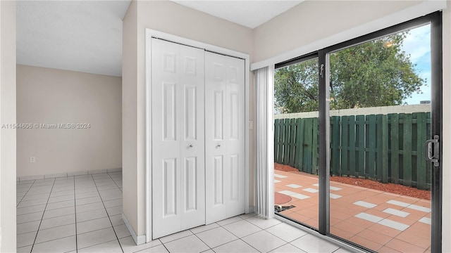 doorway with light tile patterned flooring