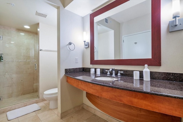 bathroom featuring vanity, walk in shower, tile floors, and toilet