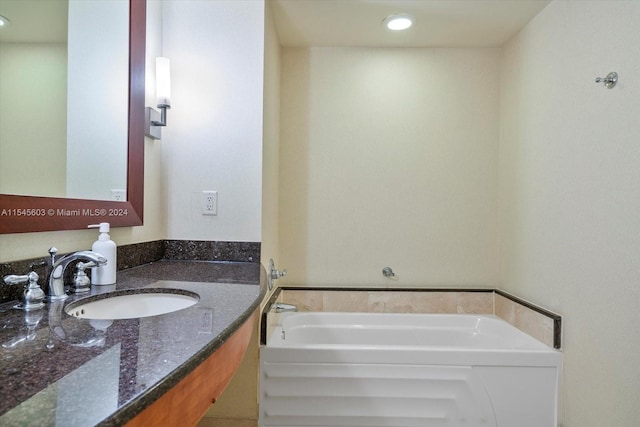 bathroom featuring a bathing tub and oversized vanity