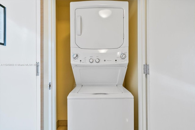 washroom featuring stacked washer and clothes dryer