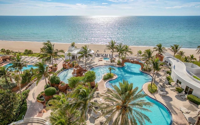 bird's eye view featuring a water view and a beach view