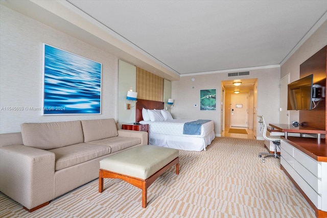 bedroom with light carpet and ornamental molding