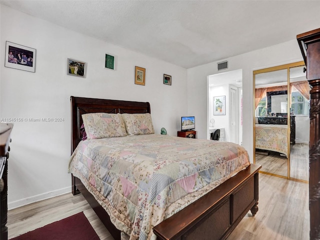 bedroom featuring light hardwood / wood-style flooring and a closet