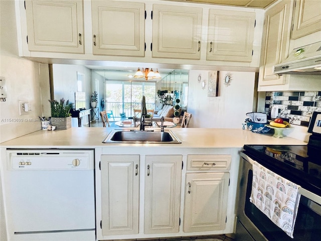 kitchen featuring white dishwasher, an inviting chandelier, stainless steel range with electric stovetop, sink, and tasteful backsplash