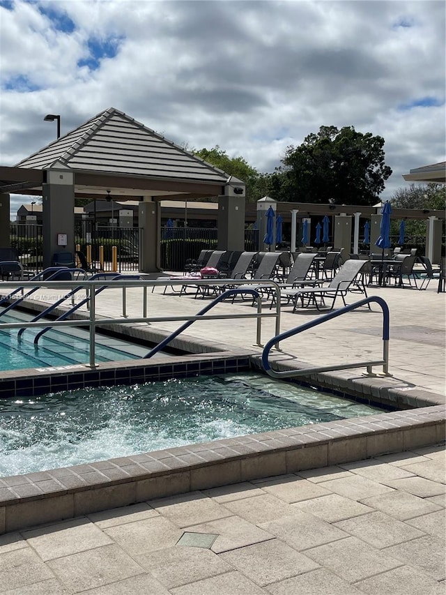 view of pool with a community hot tub