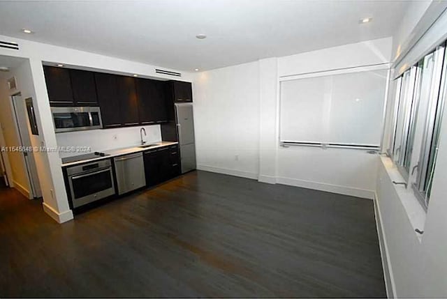 kitchen featuring dark hardwood / wood-style flooring, appliances with stainless steel finishes, and sink