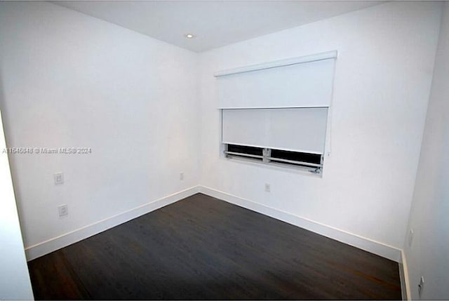 empty room with dark hardwood / wood-style floors