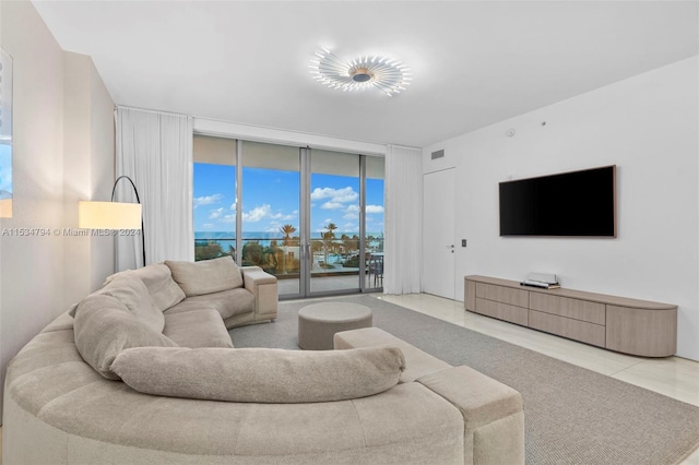 living room featuring light tile patterned floors and floor to ceiling windows