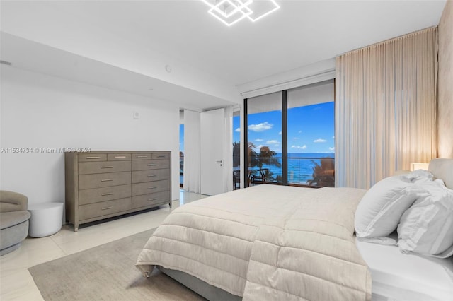 bedroom with access to exterior, floor to ceiling windows, and light tile patterned flooring