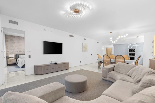 living room with a chandelier and light tile patterned floors