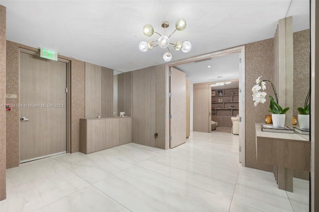 interior space with tile patterned flooring and an inviting chandelier