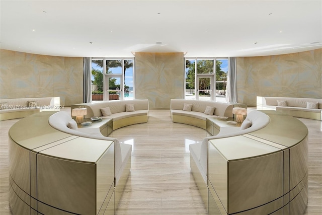 living room featuring floor to ceiling windows and a healthy amount of sunlight