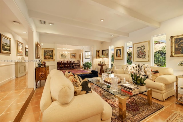 tiled living room featuring a notable chandelier and beamed ceiling