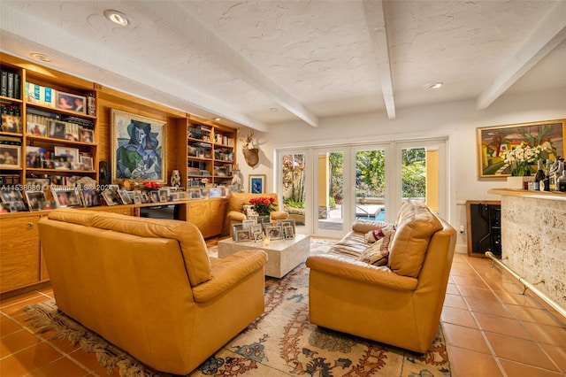 tiled living room featuring built in features, a textured ceiling, french doors, and beamed ceiling