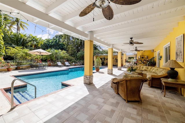 view of swimming pool featuring ceiling fan and a patio