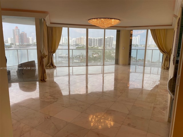 empty room featuring floor to ceiling windows and a water view