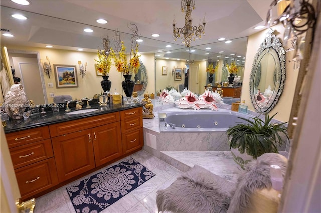 bathroom featuring tile patterned flooring, tiled tub, a raised ceiling, vanity, and a chandelier