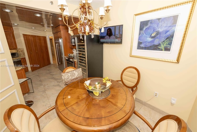 dining room featuring a chandelier and light tile patterned floors