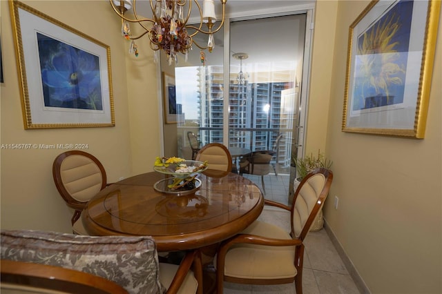 dining space with a notable chandelier and light tile patterned floors