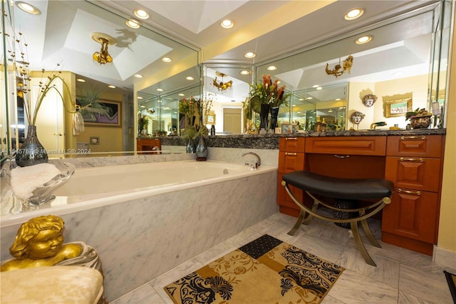 bathroom featuring vanity, lofted ceiling, and tiled bath