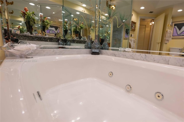 bathroom with toilet and a tub to relax in