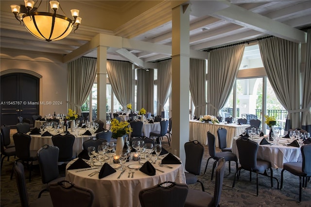 dining space featuring a notable chandelier, ornamental molding, and beam ceiling