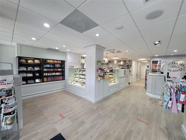 interior space with light hardwood / wood-style floors and a drop ceiling