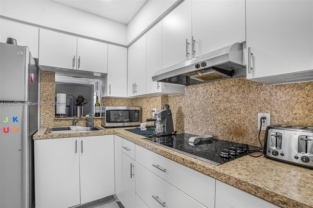 kitchen featuring appliances with stainless steel finishes, sink, tasteful backsplash, and white cabinets