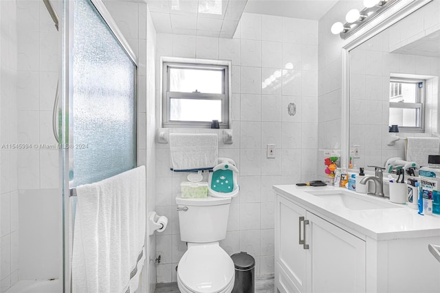 bathroom featuring toilet, radiator heating unit, vanity with extensive cabinet space, tile walls, and walk in shower