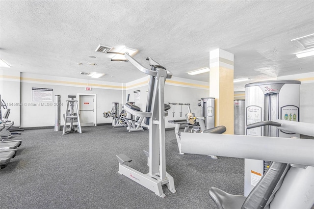 exercise room featuring a textured ceiling