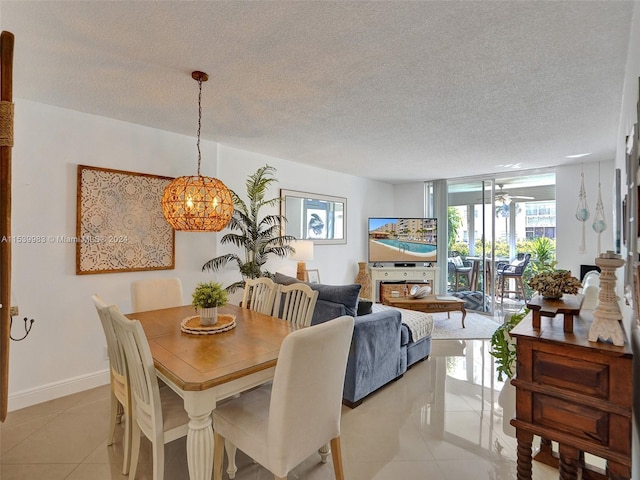 tiled dining room featuring a notable chandelier and a textured ceiling