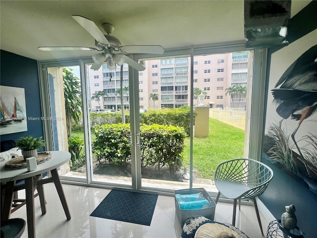 entryway with ceiling fan and expansive windows