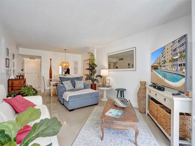 living room with a textured ceiling and light tile patterned floors