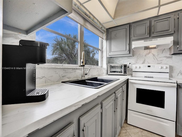 kitchen featuring sink, gray cabinets, light tile flooring, white electric range, and tasteful backsplash