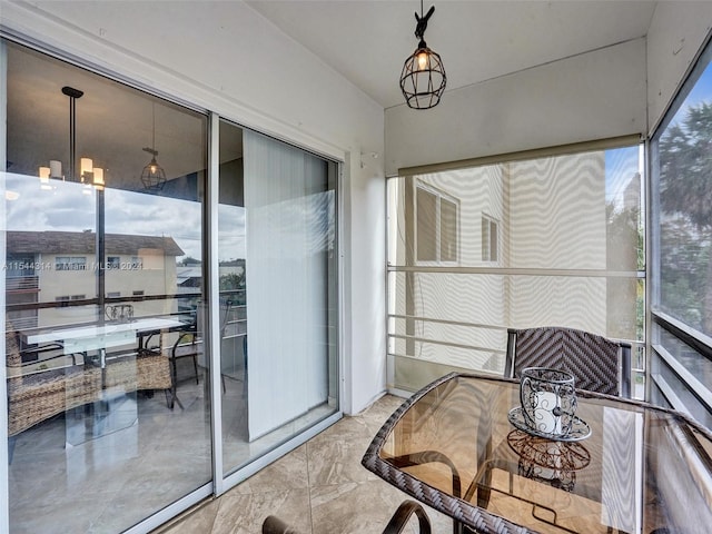 sunroom featuring a chandelier