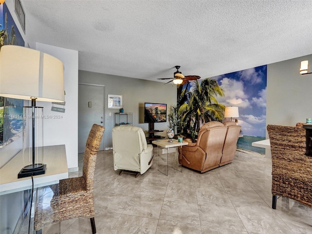 tiled living room featuring ceiling fan and a textured ceiling