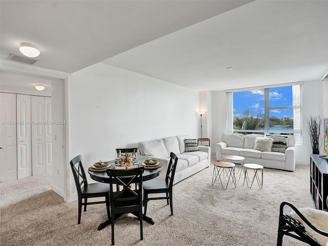 dining room featuring light carpet