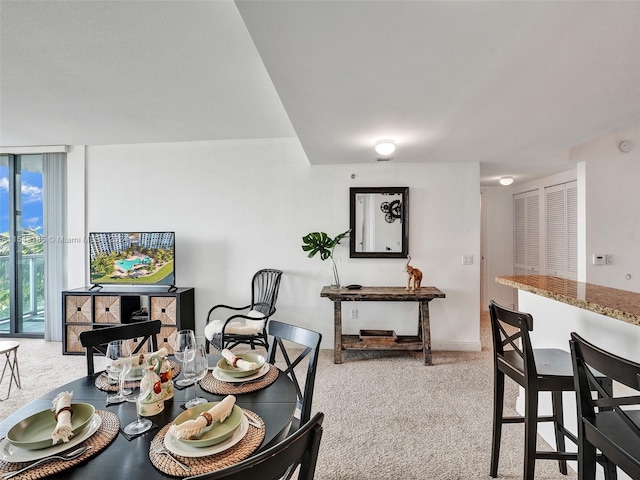 dining space with light colored carpet