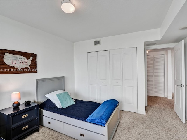 carpeted bedroom featuring a closet