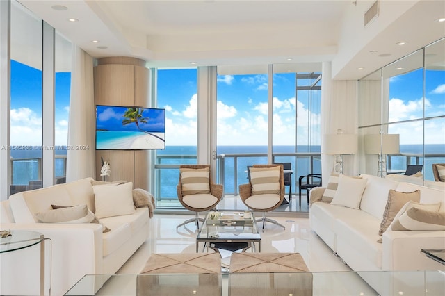 living room featuring a water view and expansive windows