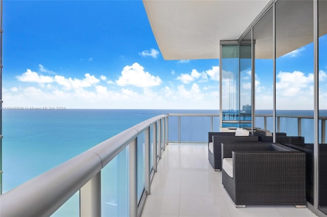 balcony with a water view and outdoor lounge area