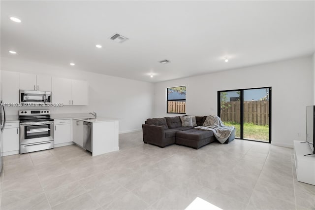 living room with light tile patterned floors and sink